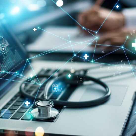 Stethoscope on top of a laptop. Blue network of health icons